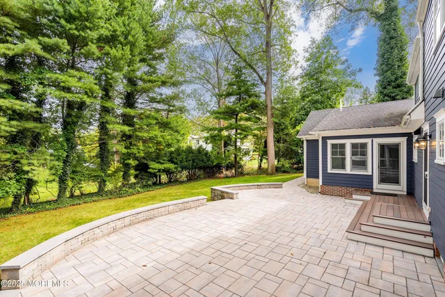 a view of a house with a yard and sitting area