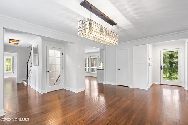a view of an entryway with wooden floor