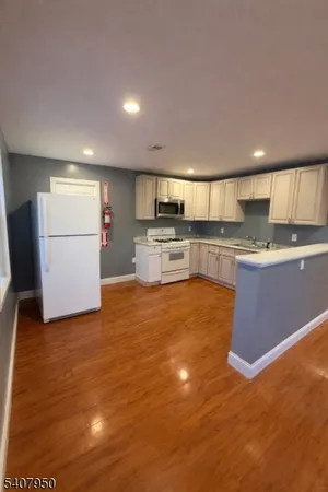 a kitchen with stainless steel appliances granite countertop a refrigerator sink and cabinets
