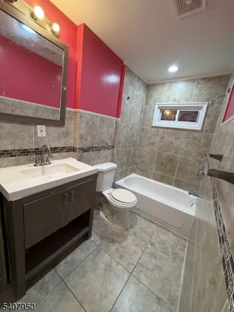 a bathroom with a sink a toilet a mirror and vanity