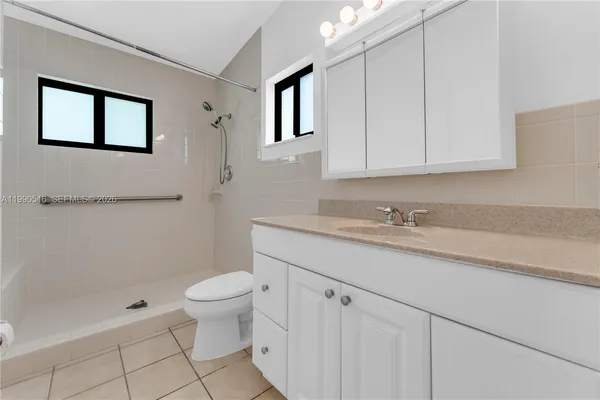 a bathroom with a shower and toilet