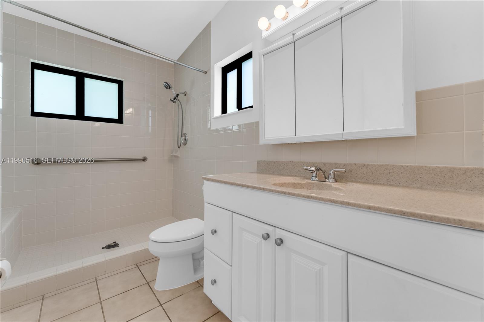 10020 Southwest 102nd Ave Road Miami, FL 33176 - Photo 16 of 27 a bathroom with a granite countertop sink a toilet and shower