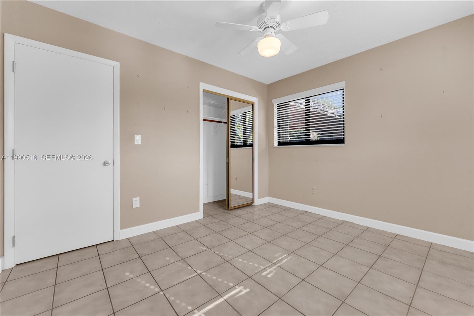 10020 Southwest 102nd Ave Road Miami, FL 33176 - Photo 18 of 27 a view of an empty room with window and chandelier fan