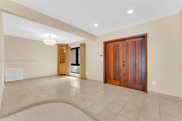 an empty room with closet and windows