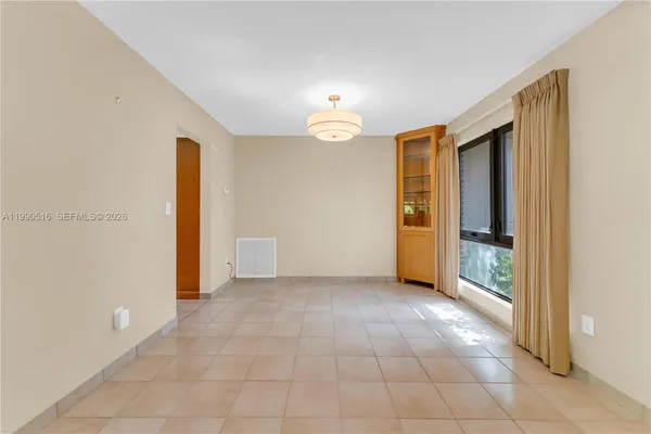an empty room with closet and a chandelier fan