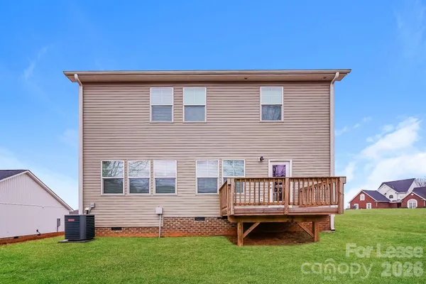 a view of backyard with deck and garden