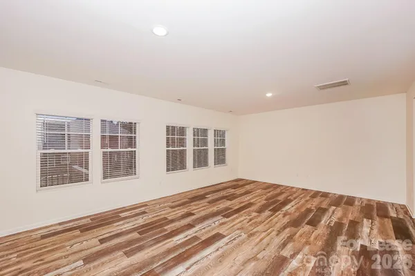 a view of a livingroom with wooden floor and closet