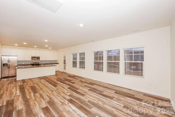 a view of kitchen with sink and wooden floor