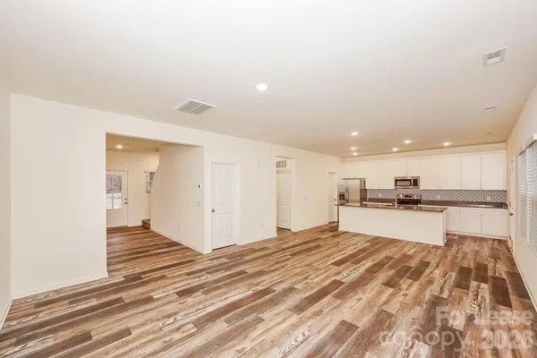 a kitchen with stainless steel appliances granite countertop a sink refrigerator and microwave