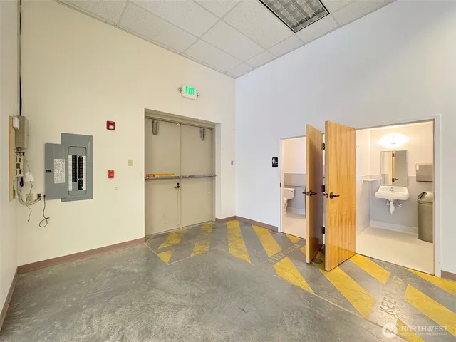a bathroom with a toilet sink and mirror