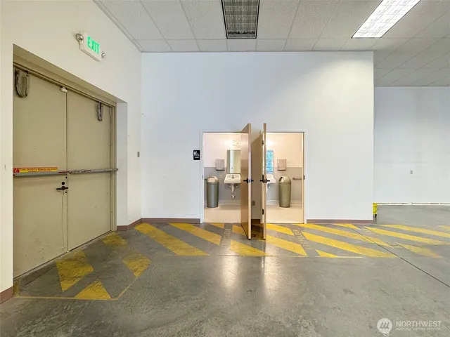 a bathroom with a toilet a sink and mirror