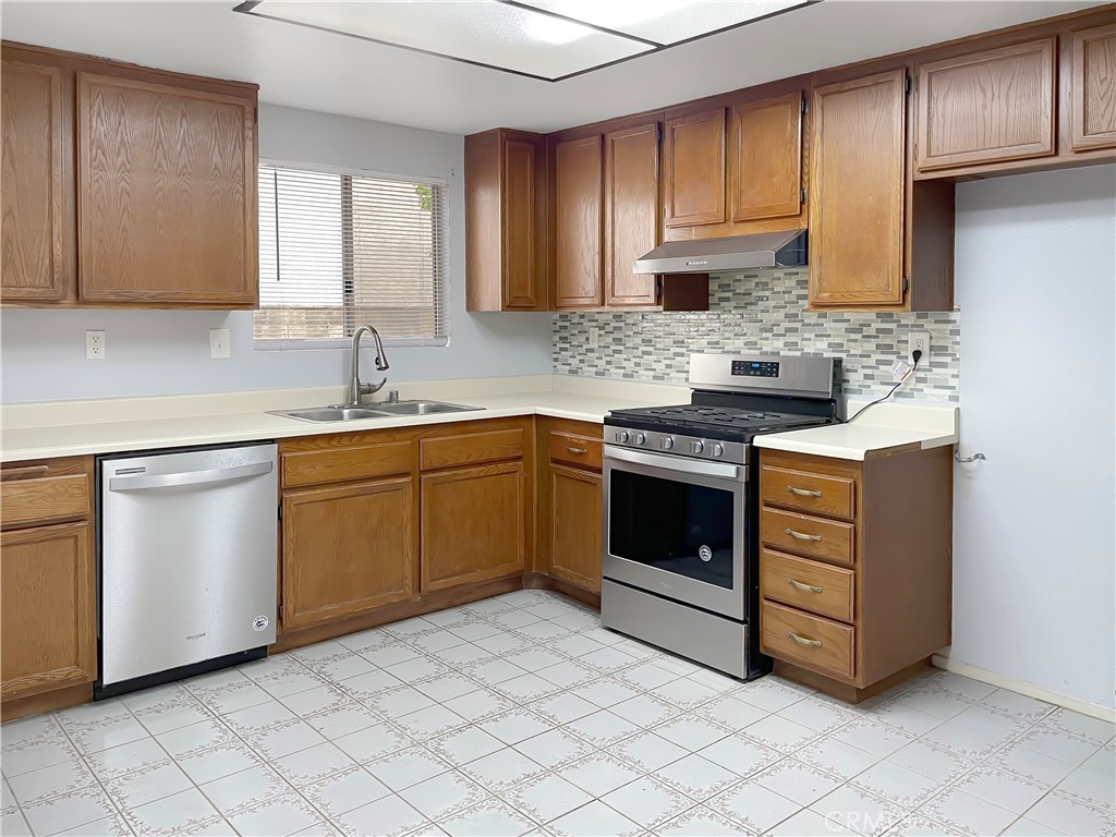 598 Armitos Place Diamond Bar, CA 91765 - Photo 8 of 26 a kitchen with a stove sink and cabinets