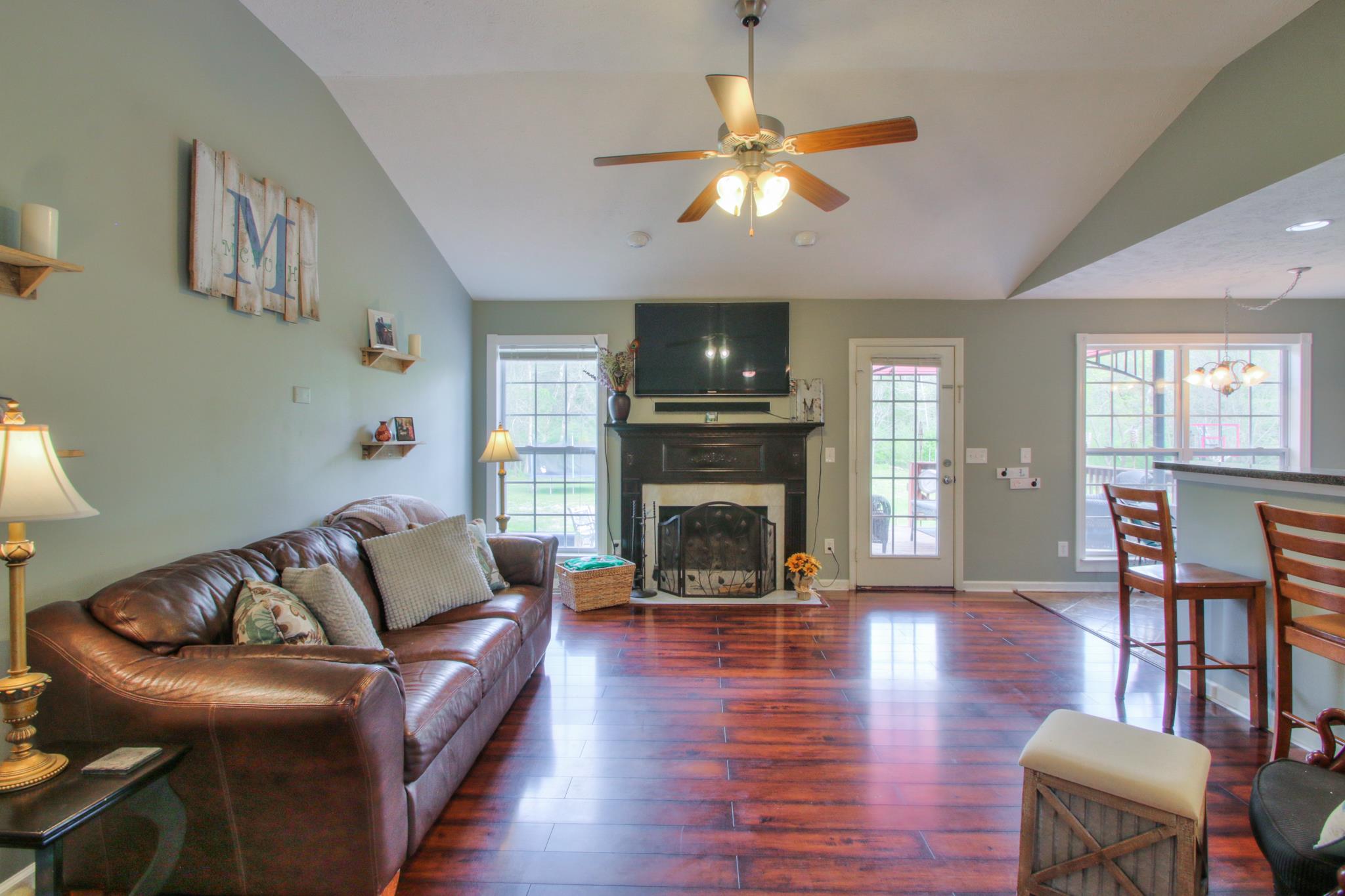 556 Windy Road Mount Juliet, TN 37122 - Photo 3 of 12 a living room with furniture a fireplace and a flat screen tv