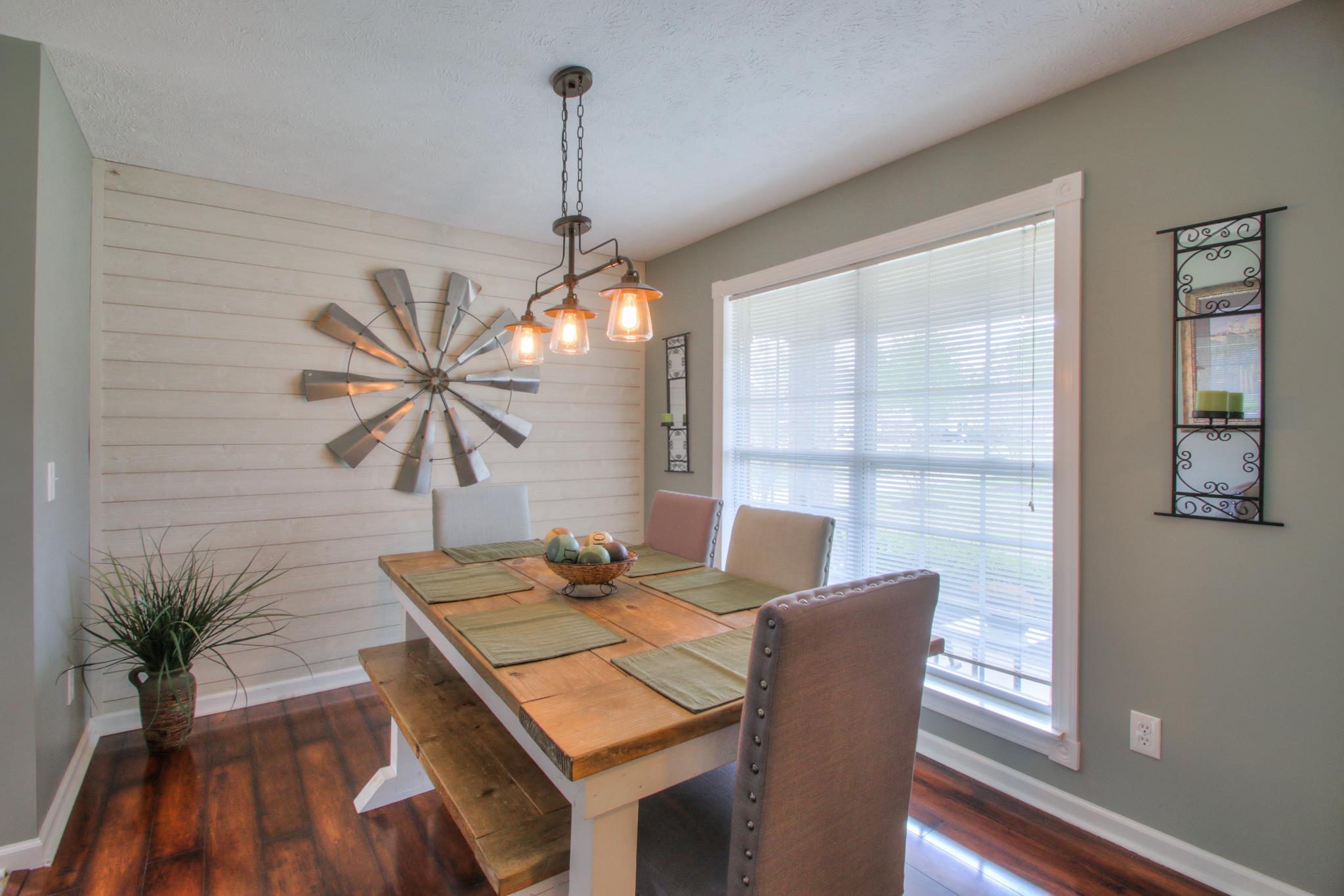 556 Windy Road Mount Juliet, TN 37122 - Photo 4 of 12 a dining room with furniture a chandelier and wooden floor