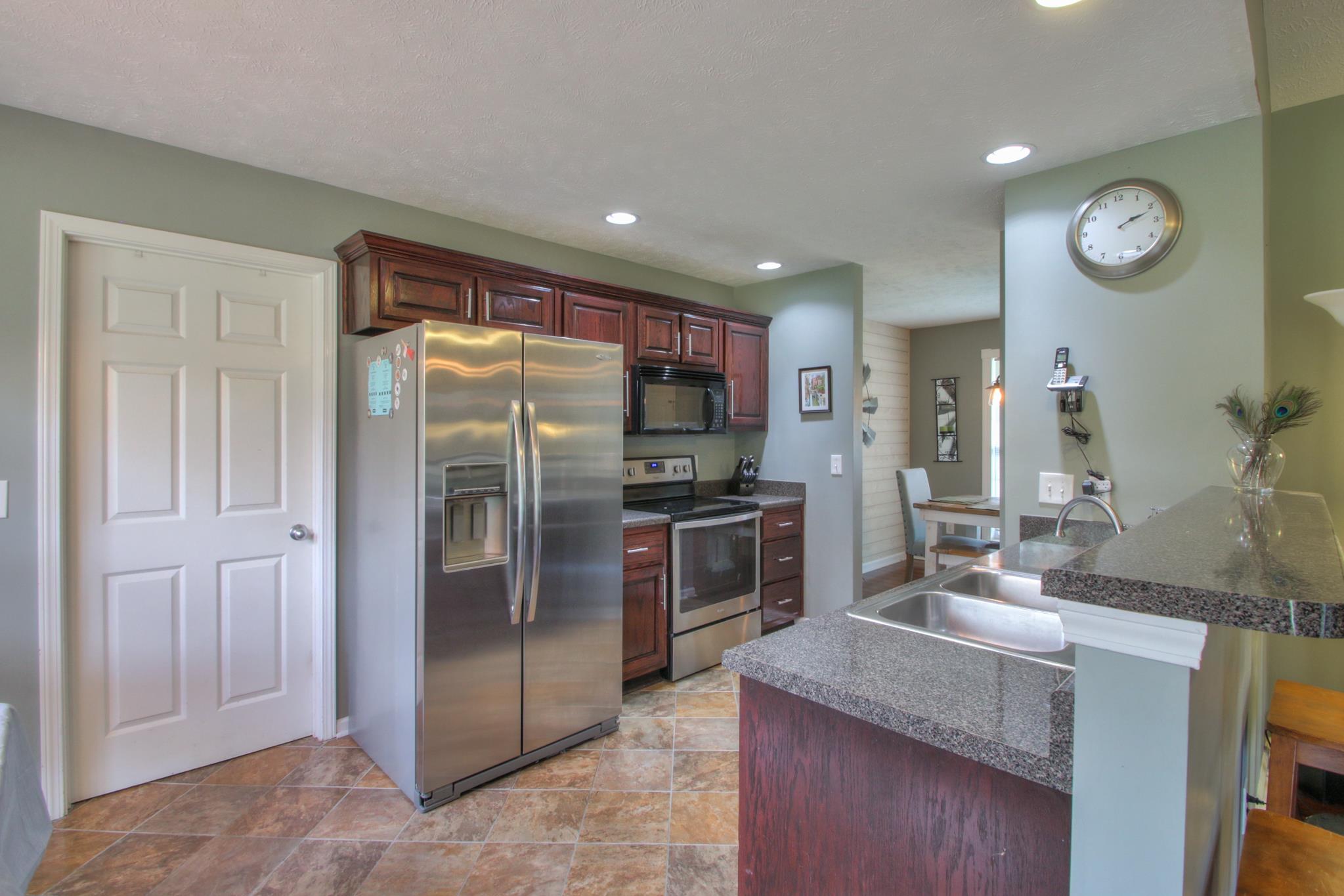 556 Windy Road Mount Juliet, TN 37122 - Photo 5 of 12 a kitchen with stainless steel appliances granite countertop a refrigerator and a sink
