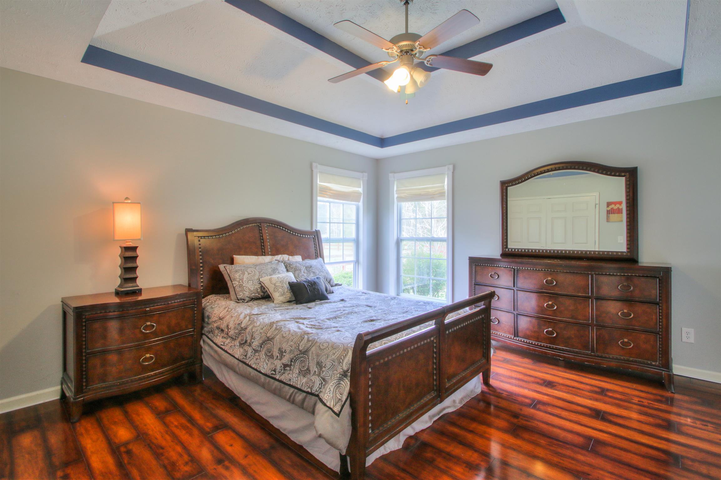 556 Windy Road Mount Juliet, TN 37122 - Photo 6 of 12 a bedroom with a bed and a mirror on dresser