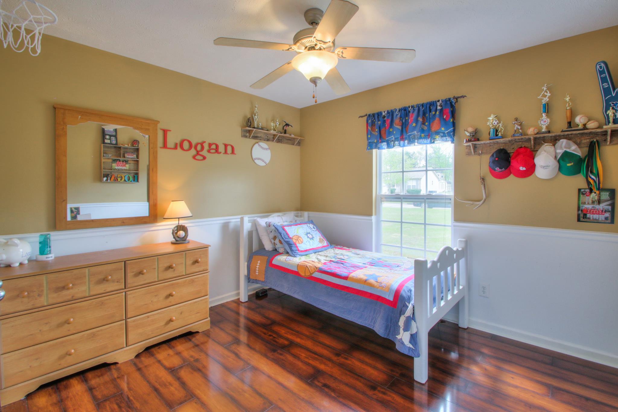 556 Windy Road Mount Juliet, TN 37122 - Photo 7 of 12 a bedroom with a bed and a chandelier