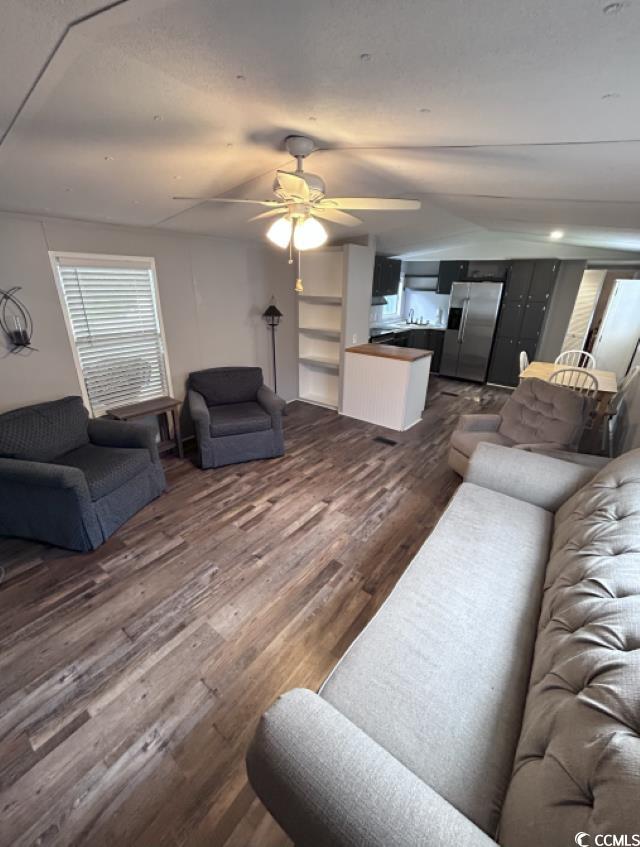 356 Calhoun Drive Murrells Inlet, SC 29576 - Photo 10 of 26 Living area with dark wood finished floors, ceiling fan, and vaulted ceiling