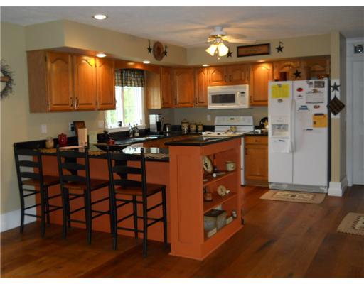 301 Harbison Road Sarver, PA 16055 - Photo 7 of 18 Kitchen. The kitchen features a breakfast bar, oak cupboards, message center, pantry and extends into the cozy family centered eating area.