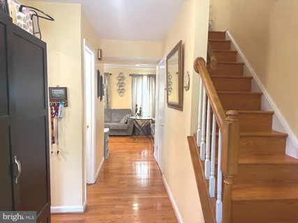 a view of a hallway with a livingroom and furniture