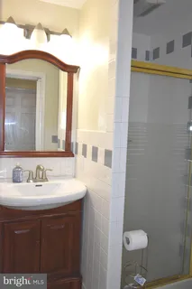 a bathroom with a shower and a sink
