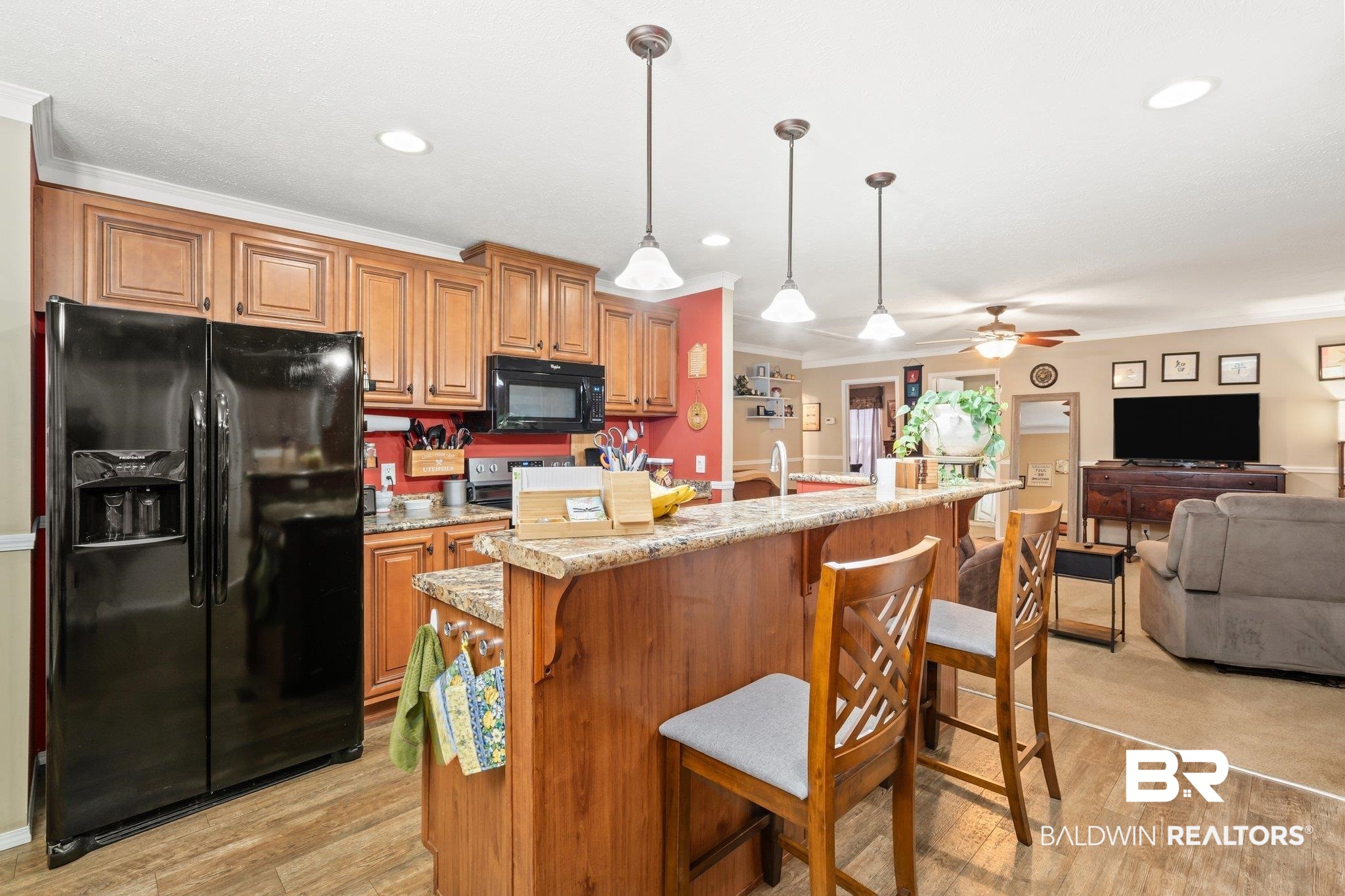 4510 Brannon Road Wilmer, AL 36587 - Photo 5 of 36 Kitchen featuring light colored carpet, black appliances, a kitchen island with sink, and ceiling fan
