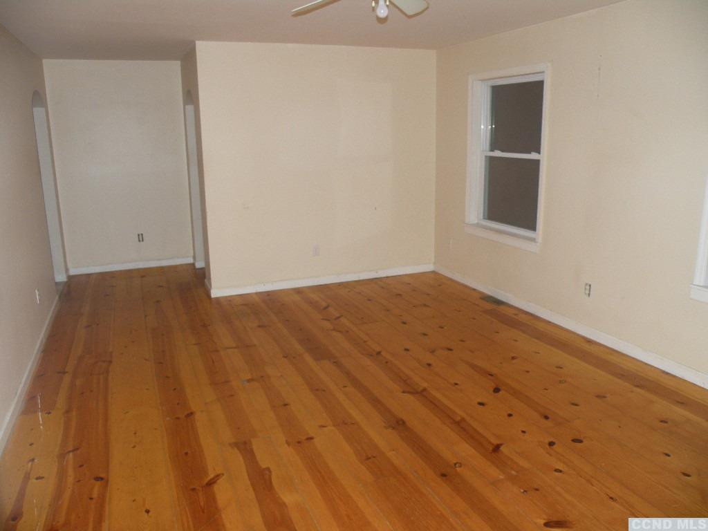 618 Bean River Road Pine Plains, NY 12546 - Photo 10 of 15 a view of an empty room with wooden floor and a window