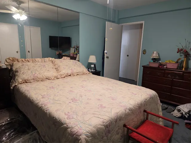 a bedroom with a bed and a mirror