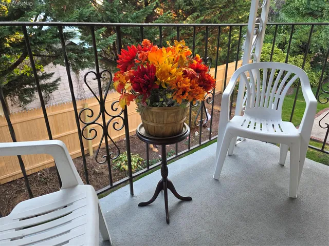 a view of a chairs and table in the balcony