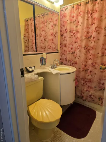 a bathroom with a toilet and a sink