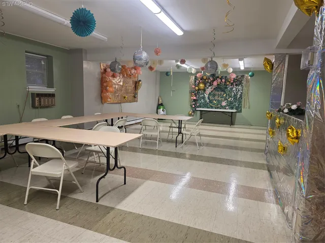 a view of a dining room with furniture and chandelier