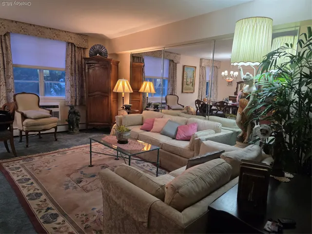 a living room with furniture and a chandelier