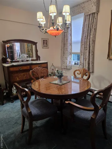 a view of a dining room with furniture and a chandelier