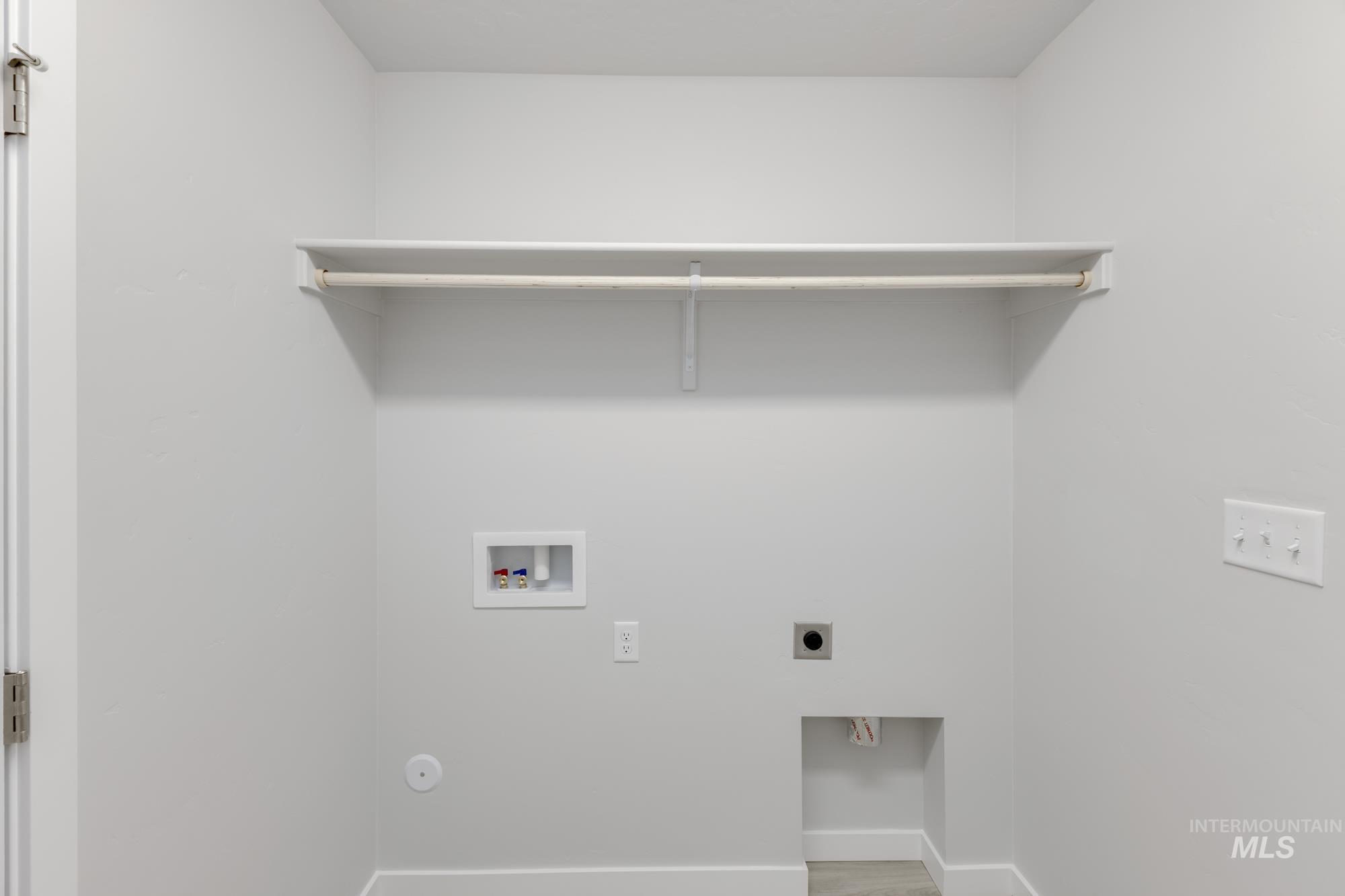 13337 Scrape Street Caldwell, ID 83607 - Photo 19 of 19 Laundry area featuring a utility hookup, integrated shelf, and hanging rod