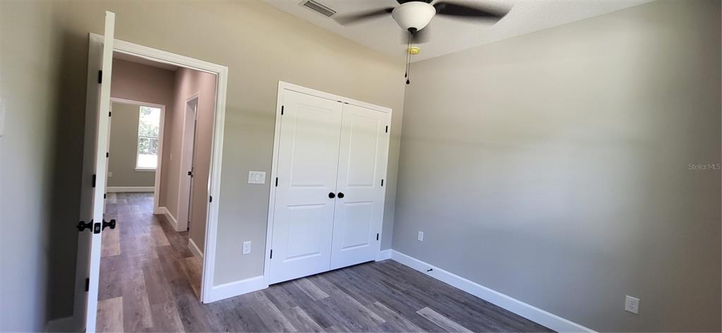1666 Berrybush Street Bunnell, FL 32110 - Photo 18 of 26 a view of a hallway with wooden floor