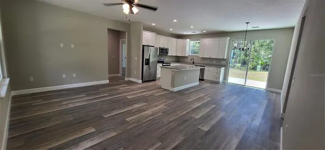 a kitchen with a refrigerator and a sink