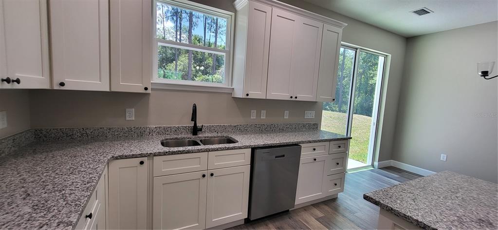 1666 Berrybush Street Bunnell, FL 32110 - Photo 7 of 26 a kitchen with a sink cabinets and window