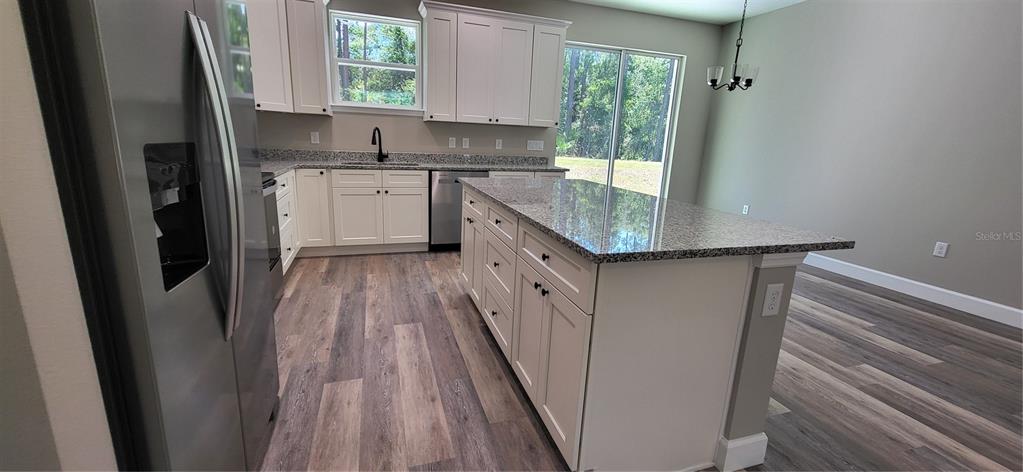 1666 Berrybush Street Bunnell, FL 32110 - Photo 8 of 26 a kitchen with a sink a window and stainless steel appliances