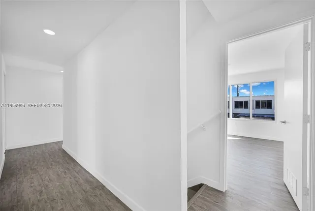 a view of hallway with wooden floor