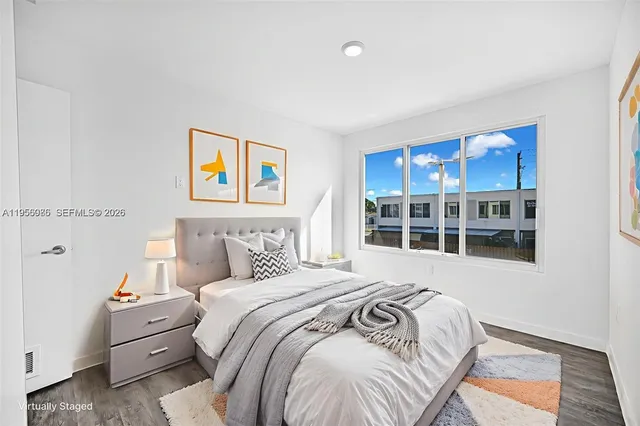 a bedroom with a bed and a window