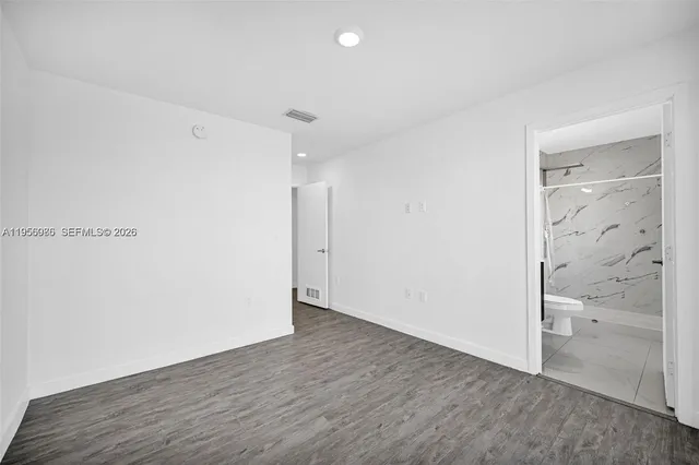a view of a room with wooden floor