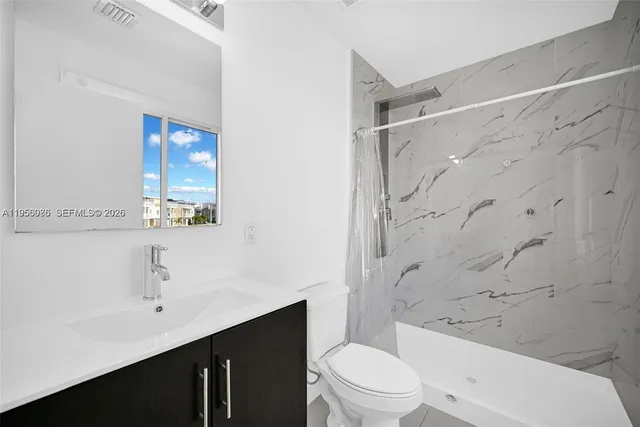 a bathroom with a toilet and a sink