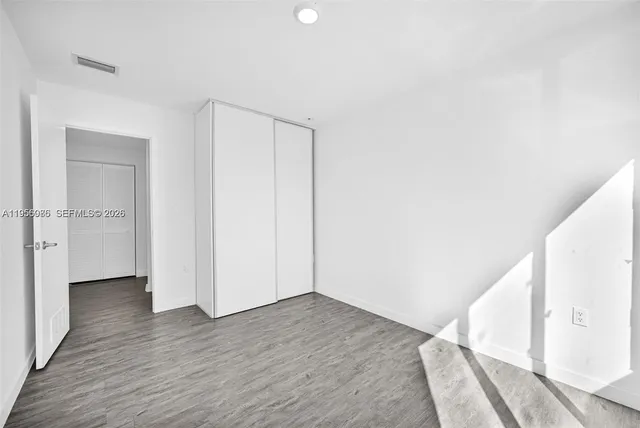 a bathroom with a sink toilet vanity and shower