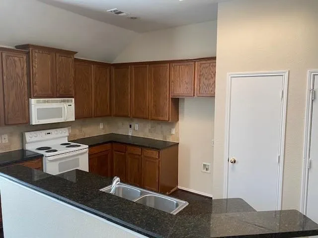 a kitchen with a sink and cabinets