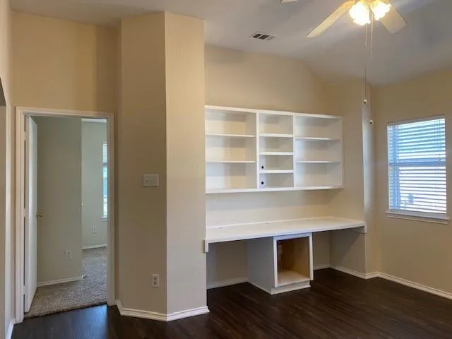 a room with wooden floor and a fireplace