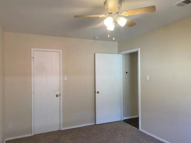 a view of an empty room with a fan