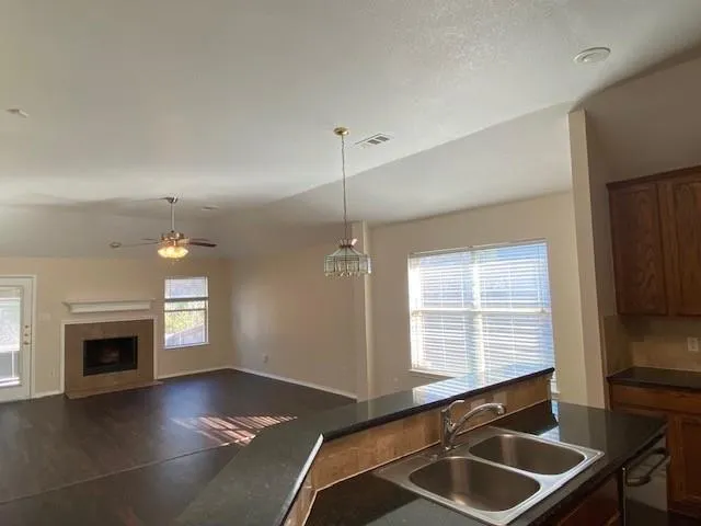 a kitchen with sink cabinets and a fireplace