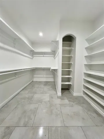a view of walk in closet with empty racks