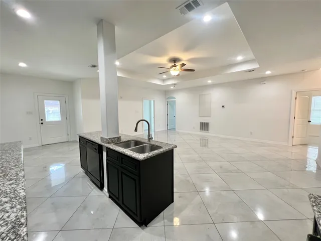 a kitchen with stainless steel appliances granite countertop a sink and cabinets