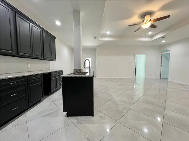 a kitchen with a sink and cabinets